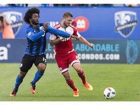 New England Revolution's Chris Tierney, right, challenges Montreal Impact's Michael Salazar at Saputo Stadium on Saturday.