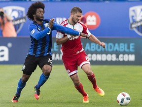 New England Revolution's Chris Tierney, right, challenges Montreal Impact's Michael Salazar during first half MLS soccer action, in Montreal on Saturday, July 2, 2016.