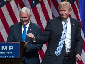 Republican presidential candidate Donald Trump, right, introduces Gov. Mike Pence, R-Ind., during a campaign event to announce Pence as the vice-presidential running mate on, Saturday, July 16, 2016, in New York.