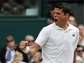 Milos Raonic of Canada celebrates a point against Roger Federer of Switzerland during their men's semifinal singles match at the Wimbledon Tennis Championships in London, July 8, 2016.