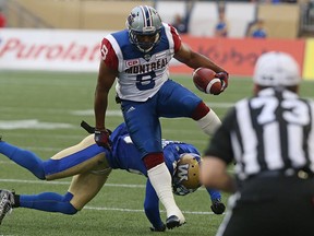 Montreal Alouettes SB Nik Lewis leaps through a Winnipeg Blue Bombers tackle attempt during CFL action in Winnipeg on Wed., June 8, 2016.