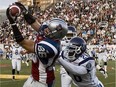 Alouettes slotback Ben Cahoon makes one of his 1,017 career receptions as Argonauts cornerback Jordan Younger defends in 2009 at Molson Stadium.