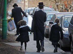 Hassidic Jews walk down Hutchison St.