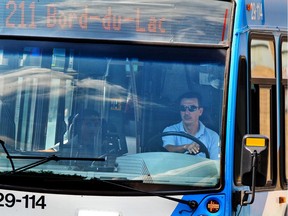 An STM bus driver steers his bus through the streets of the St. Henri district of Montreal, Thursday August 16, 2012.