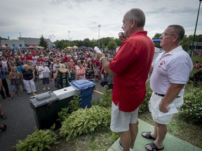 After Longueuil Mayor Caroline St-Hilaire barred councillors, Wade Wilson left, and Robert Myles, right, from speaking at Canada Day festivities in Greenfield Park, the pair spoke on the opposite side of the park after the official ceremony was over.