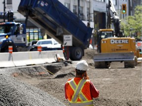 A worksite overseer makes a call as work continues on Saint-Denis in Montreal on Monday July 11, 2016.