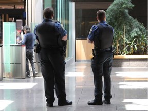 Two officers at the Montreal courthouse wear their regular uniform on July 12, 2016. The union representing Quebec's special constables decided to stop wearing camouflage pants.