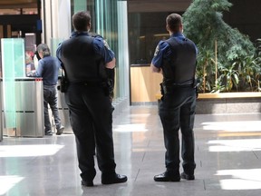 Two officers at the Montreal courthouse wear their regular uniform on July 12, 2016. The union representing Quebec's special constables has decided to stop wearing camouflage pants.
