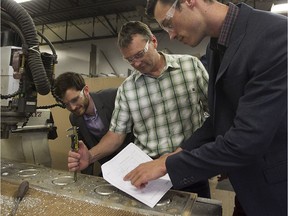 Jean Lapointe, president of Kalitec, between his two sons — Charles-Eméric, left, and Anthony — at the company's plant in Laval on July 13, 2016. The company makes road signs and street signs and has been in business for 25 years.