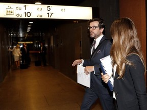 Julie Snyder's lawyer, Mathieu Piche-Messier, left, and an unidentified woman, leave the courtroom during a recess in Montreal on Wednesday. Snyder is requesting an injunction to stop a private investigator from following her.