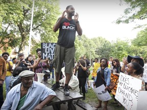 Svens Telemaque stands on a picnic table to address the crowd during a Black Lives Matter rally in Nelson Mandela Park in Montreal in July 2016.