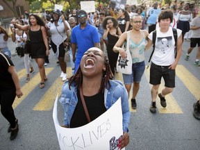 Venetta Solena-Gordon cries out as demonstrators march down Victoria Ave. in the Côte des Neiges district of Montreal following a Black Lives Matter rally in Nelson Mandela Park in Montreal Wednesday July 13, 2016.