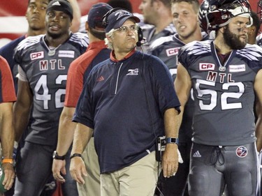 Alouettes head coach and general manager Jim Popp watches the last few minutes of Canadian Football League game against Hamilton Tiger-Cats in Montreal, Friday, July 15, 2016. (