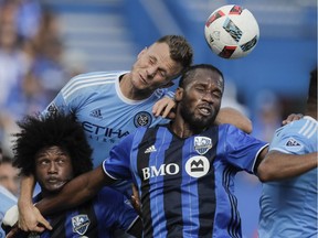 Impact forward Didier Drogba, right, goes up for a header against New York City FC defender Frédéric Brillant, centre, and Montreal forward Michael Salazar, left, during the first half of their MLS soccer match at Saputo Stadium in Montreal on Sunday, July 17, 2016.