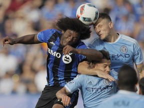 Montreal Impact forward Michael Salazar, left, battles for the ball against New York City FC defender Frederic Brillant, right, during the second half of their MLS soccer match at Saputo Stadium in Montreal on Sunday, July 17, 2016.