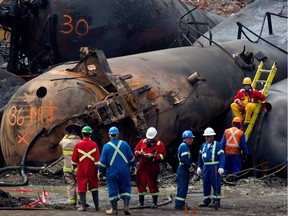 Cleanup crews prepare to remove one of the toppled rail cars in Lac-Mégantic July 19, 2013.