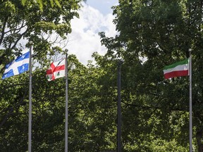 A Patriote flag (drapeau des patriots) seen on the right side in the place where an Italian flag should be at the Petite-Italie park in Little Italy in Montreal on Tuesday, July 19, 2016. (Dario Ayala / Montreal Gazette) ORG XMIT: 56716