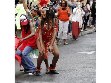 A Carifiesta Parade participant dances with a spectator during the Carifiesta in Montreal on Saturday July 2, 2016.