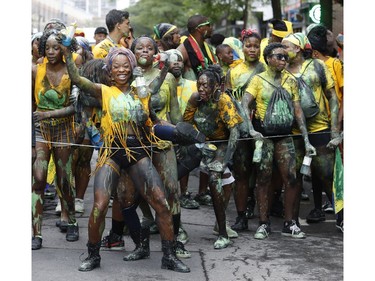 People dance as they follow a float with a Calypso DJ during the 2016 Carifiesta Parade in Montreal. This year's edition of the festival starts at 10 a.m. on Saturday, July 8.