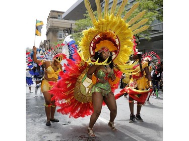People dance along Ste-Catherine St. during the 2016 Carifiesta Parade in Montreal. This year's edition of the festival starts at 10 a.m. on Saturday, July 8.