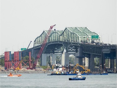 Cranes are installed on construction platforms as work continues on construction of the new Champlain Bridge right next to the existing one in Montreal Thursday July 21, 2016.
