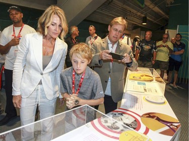 MONTREAL, QUE.: JULY 21, 2016 -- Nadia Comaneci and her son Dylan and husband Bart Conner tour an exhibit at the Olympic Park in Montreal Thursday July 21, 2016 commemorating the 1976 Olympic Summer Games in Montreal. (John Mahoney} / MONTREAL GAZETTE) ORG XMIT: 56717 - 3466