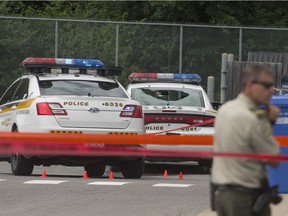 A police car with its back window shot out sits beside Surete du Quebec headquarters, at 599 Harwood Blvd in Vaudreuil-Dorion on Tuesday, July 26, 2016.