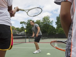 Tennis instructor Benjamin Mooney gives lessons to children at a court on Hingston Ave. near Somerled Ave. in N.D.G. on Tuesday, July 26, 2016.