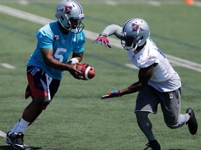 Alouettes quarterback Kevin Glenn hands the ball off to Montreal Stefan Logan during a team practice in Montreal on July 27, 2016.