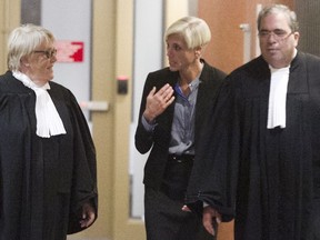 Psychiatrist Marie-Frédérique Allard, centre, walks with lawyers, during morning break of the Richard Henry Bain's murder trial on Thursday July 28, 2016.