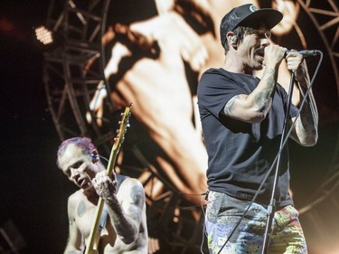 Anthony Kiedis, right, and bassist Flea, left, of the American band Red Hot Chili Peppers perform during Day One of the Osheaga Music and Arts Festival at Parc Jean-Drapeau in Montreal on Friday, July 29, 2016.