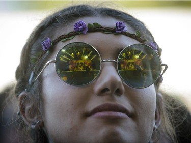 A music fan enjoys the performance by the American rock band The Arcs on Day Two of the Osheaga Music and Arts Festival at Parc Jean-Drapeau in Montreal on Saturday, July 30, 2016.