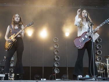 Alana Haim, left, and sister Danielle Haim, right, of the American rock band Haim perform on Day Two of the Osheaga Music and Arts Festival at Parc Jean-Drapeau in Montreal on Saturday, July 30, 2016.