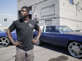 Fritz Cesar alongside two of his modified cars at his custom car garage in Montreal on Monday, July 4, 2016.