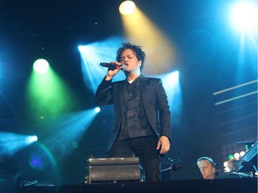 Jamie Cullum stands on the piano during the second of three big free outdoor blowout concerts at the Montreal International Jazz Festival on July 4, 2016.