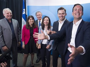 Parti Quebecois leadership hopefuls gather around president Raymond Archambault, glasses, at PQ headquarters in Montreal on Monday July 4, 2016. From left: Jean-François Lisee, Veronique Hivon, Martine Ouellet, Paul Saint-Pierre Plamondon and Alexandre Cloutier.