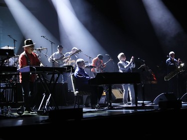 Brian Wilson of Beach Boys fame performs at the piano, middle, at Salle Wilfrid-Pelletier of Place des Arts as part of the Montreal International Jazz Festival on Thursday, July 7, 2016, along with Al Jardine and Blondie Chaplin.