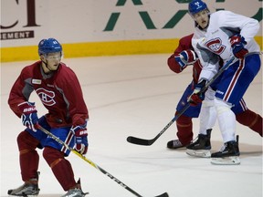 Mikhail Sergachev, left, takes part in a scrimmage during the Montreal Canadiens' rookie training camp in Montreal on Thursday July 7, 2016.  Michael McCarron, right, looks on.