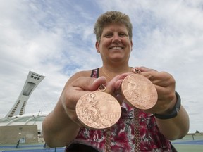 Former Olympic swimmer Anne Jardin Alexander shows the two bronze medals she won at the 1976 Olympic Games in Montreal - medals that could have been silver if it were not for the East German swimmers, now found to have been part of a doping program.