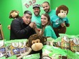 At Bad Monkey Popcorn. Chef Luciano Zeppilli, left, tastes the popcorn in their St-Laurent showroom, with the help of his cousin Elaine MacLean, marketing director. Behind are left, Fabio Zeppilli, chief operations officer, and Joseph Zeppilli, who is the company's CEO.