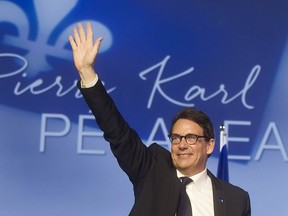 Newly elected PQ leader Pierre Karl Péladeau, waves to delegates following his first ballot win in Quebec city on  Friday, May 15, 2015.