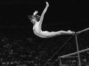 14-year-old Nadia Comaneci, of Romania,  went on to become the darling of the Games, earning six more perfect 10s. Comaneci won three Gold medals, as well as silver and bronze medals. (Seen here: Comaneci dismounts from the uneven parallel bars during a perfect "10" performance at Montreal's Summer Olympics, July 18, 1976.)