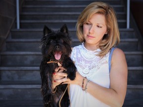Nikki the Cairn Terrier in owner Karine Garceau’s arms on Dante St. just a few steps from Café San Simeon.