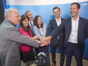 Parti Quebecois leadership candidates Jean-François Lisée, left to right, Véronique Hivon, Martine Ouellet, Paul St-Pierre Plamondon, Alexandre Cloutier with PQ president Raymond Archambault, third from the left, at a news conference Monday, July 4, 2016 in Montreal.