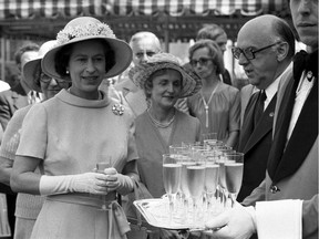 Queen Elizabeth II stands with then-mayor Jean Drapeau at a reception at Montreal city hall July 17, 1976. The Queen opened the Olympics later that afternoon.