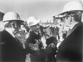 Olympic Stadium architect Roger Taillibert is flanked by Mayor Jean Drapeau, left, and Governor General Jules Léger as he explains his design at the construction site in 1975.