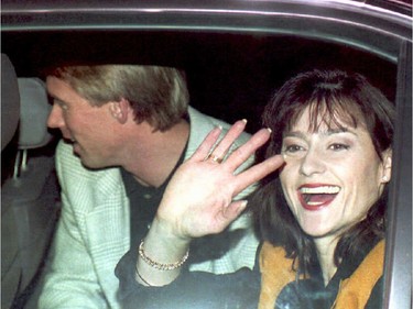 Nadia Comaneci and future husband, U.S. gymnast Bart Conner, wave to fans as they arrive in Bucharest on Nov. 21,1994. Comaneci defected from Romania in 1989.