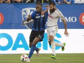 The Montreal Impact's Didier Drogba, left, challenges the Philadelphia Union's Richard Marquez during first-half MLS soccer action in Montreal, Saturday, July 23, 2016.