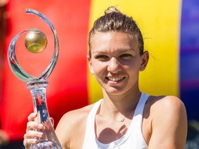 Simona Halep of Romania hoists the Rogers Cup after defeating American Madison Keys in the final at Uniprix Stadium in Montreal on July 31, 2016.