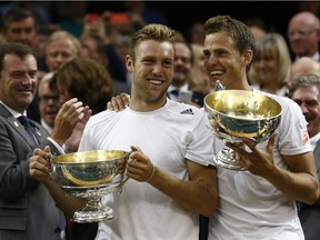 Canada's Vasek Pospisil (right) and American Jack Sock celebrate after winning Wimbledon doubles championship by beating American brothers Bob and Mike Bryan on July 5, 2014.
